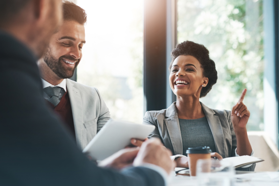 employees sitting at desk talking